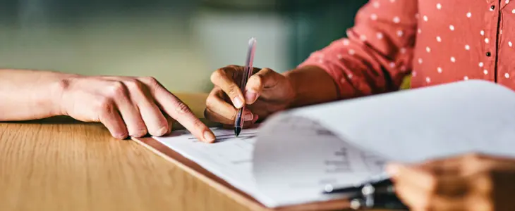 Closeup shot of two businesspeople going through paperwork